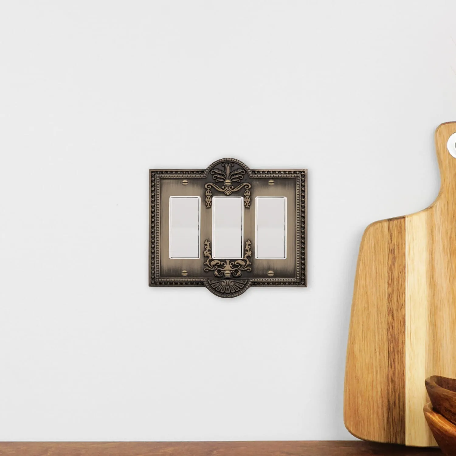 Meadows Switch Plate with Triple Rocker in Antique Brass